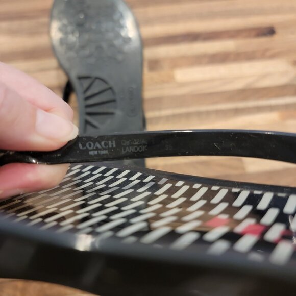 Coach Landon jelly flip flops in black with a gold bow and white pattern. - Picture 11 of 12